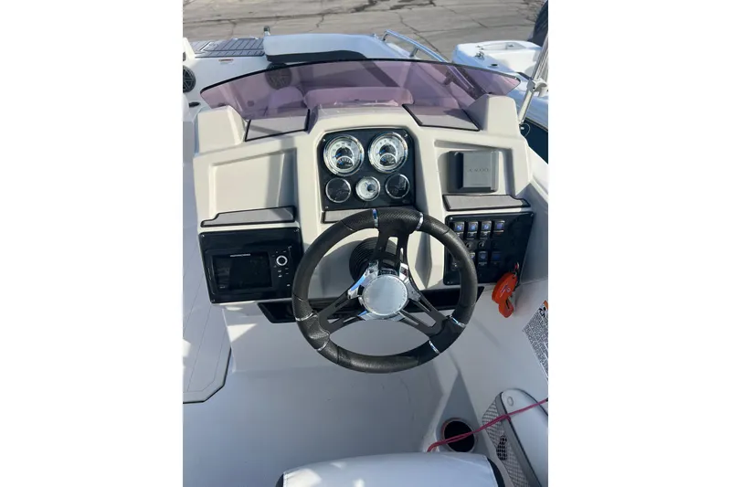 Slide: The Image of 2022 Starcraft SVX 191 OB boat dashboard with steering wheel and control panel. - 4