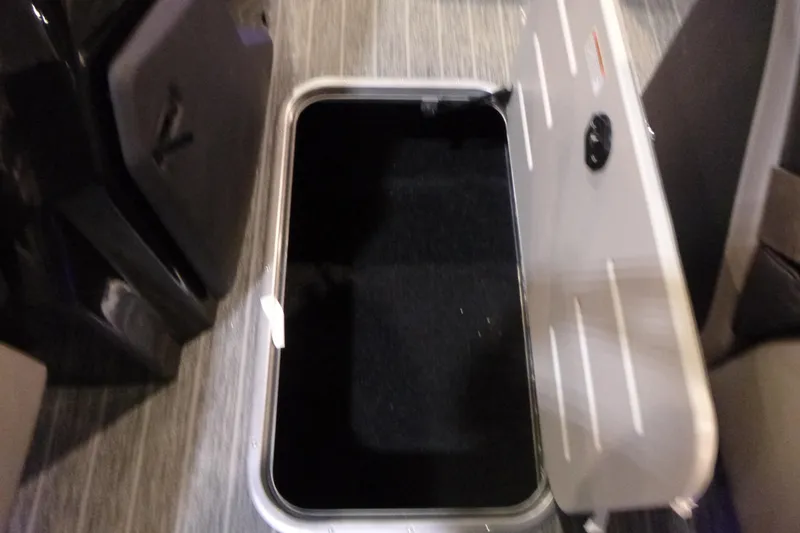 Slide: The Image of Open storage compartment in 2026 Premier 230 Intrigue RLO boat interior. - 11
