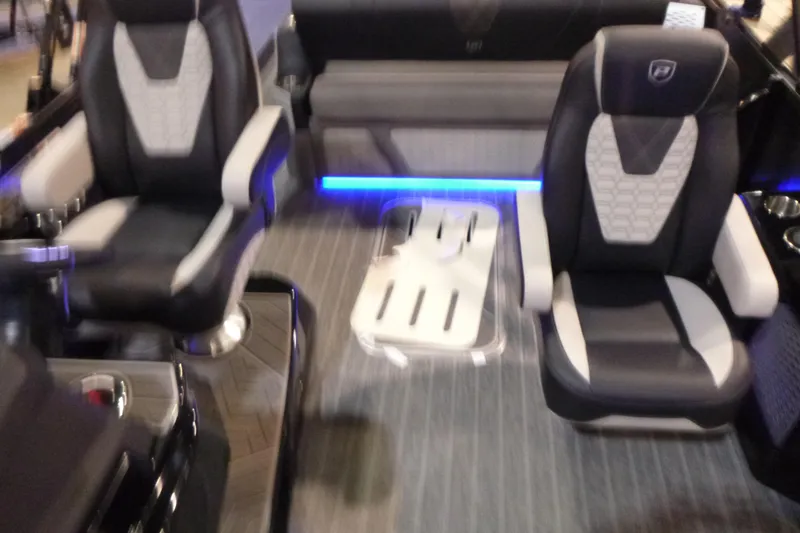 Slide: The Image of Interior of 2026 Premier 230 Intrigue RLO boat with modern seating and ambient lighting. - 12
