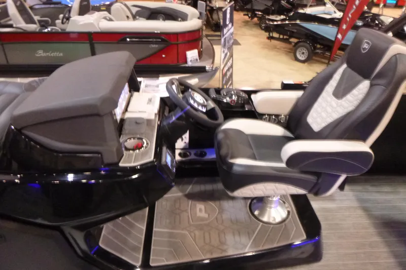 Slide: The Image of 2026 Premier 230 Intrigue RLO boat interior with luxury captain's chair and modern dashboard. - 13