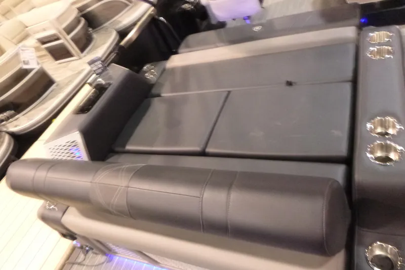 Slide: The Image of 2026 Premier 230 Intrigue RLO boat interior with luxurious seating and cup holders. - 19