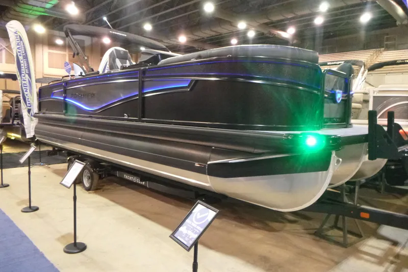 Slide: The Image of 2026 Premier 230 Intrigue RLO pontoon boat displayed indoors with vibrant lighting. - 3