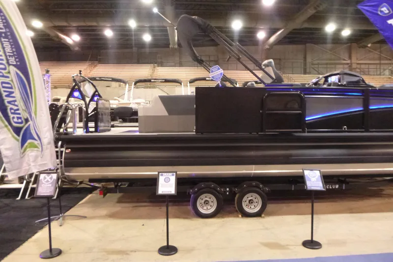 Slide: The Image of 2026 Premier 230 Intrigue RLO pontoon boat displayed indoors at a boat show. - 4