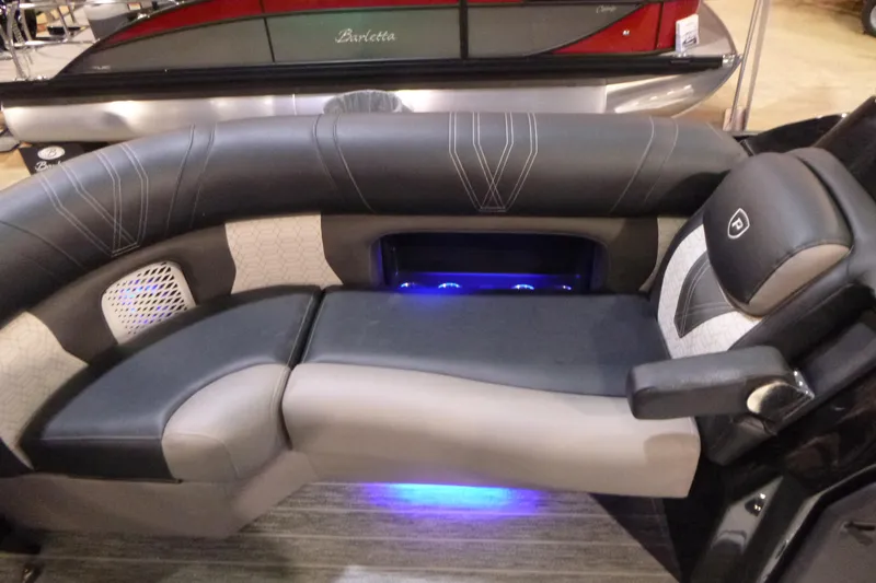 Slide: The Image of Luxurious seating on 2026 Premier 230 Intrigue RLO boat with ambient blue lighting. - 7