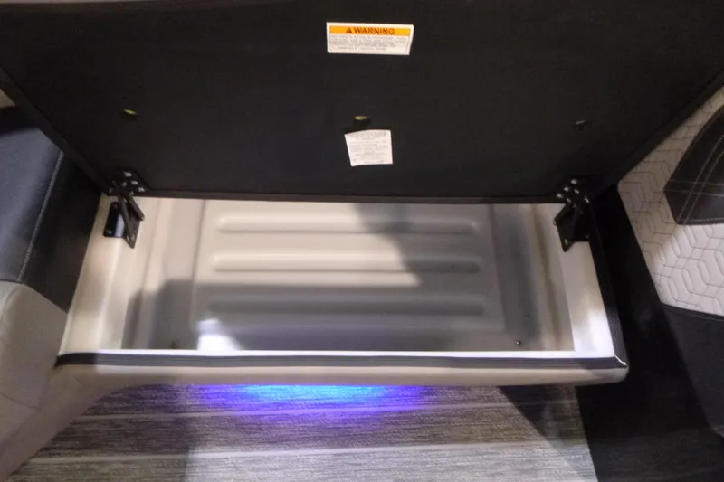 Slide: The Image of Open storage compartment in 2026 Premier 230 Intrigue RLO boat, featuring sleek interior design. - 8
