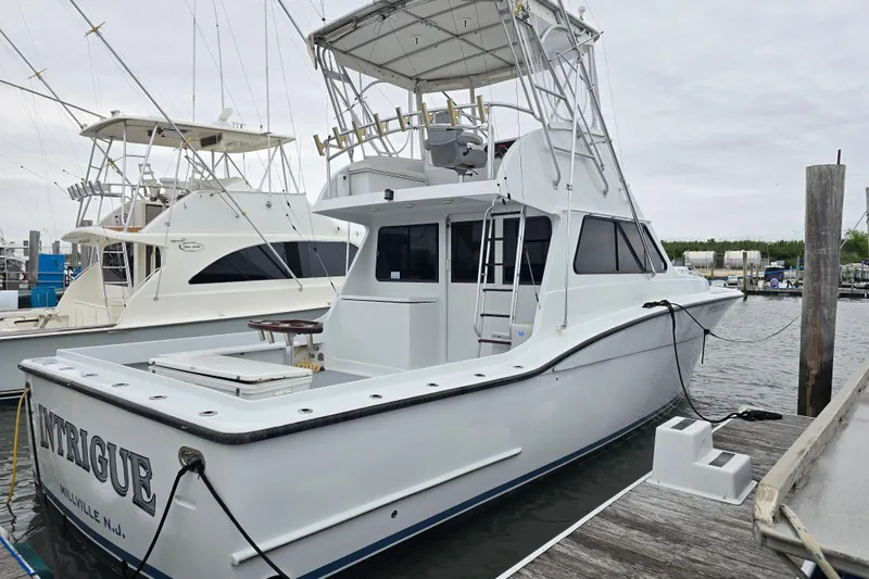 The Image of Custom 42 JM Sportfish Custom 2000 docked, featuring a spacious deck and fishing equipment. - 0