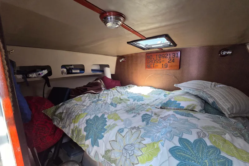 Slide: The Image of Cozy cabin interior of 2000 JM Custom 42 sailboat with floral bedding and natural light. - 11