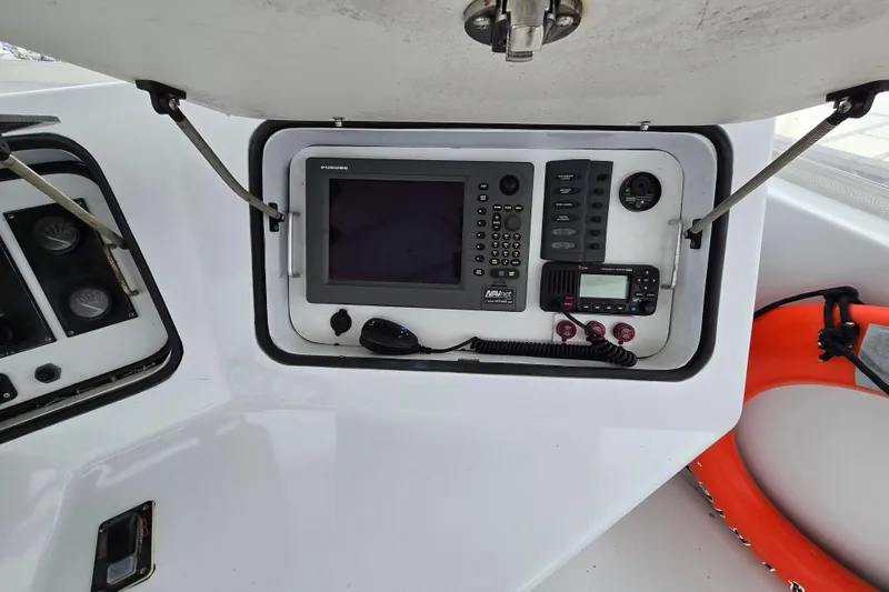 Slide: The Image of Control panel of 2000 Custom 42 JM Sportfish boat with navigation equipment. - 17