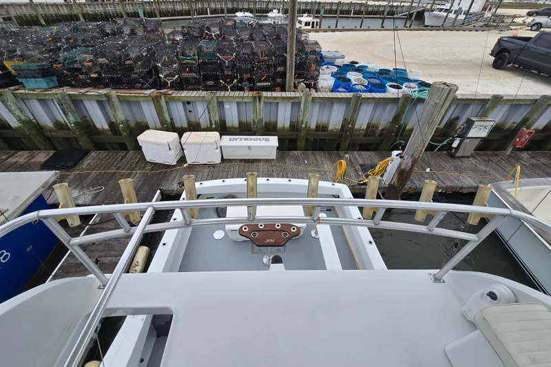 Slide: The Image of Custom 42 JM Sportfish boat docked, surrounded by fishing gear and equipment, year 2000 model. - 19