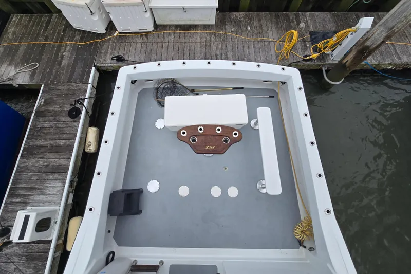 Slide: The Image of Custom 42 JM Sportfish boat deck, 2000 model, docked with fishing gear and equipment. - 21