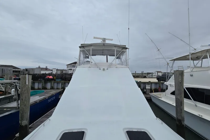 Slide: The Image of Custom 42 JM Sportfish Custom 2000 boat docked at marina under cloudy sky. - 24