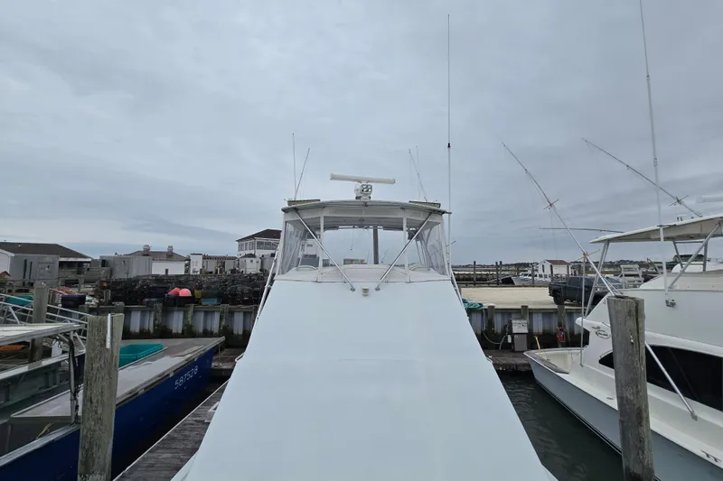 Slide: The Image of Custom 42 JM Sportfish boat docked at marina, overcast sky, 2000 model. - 25