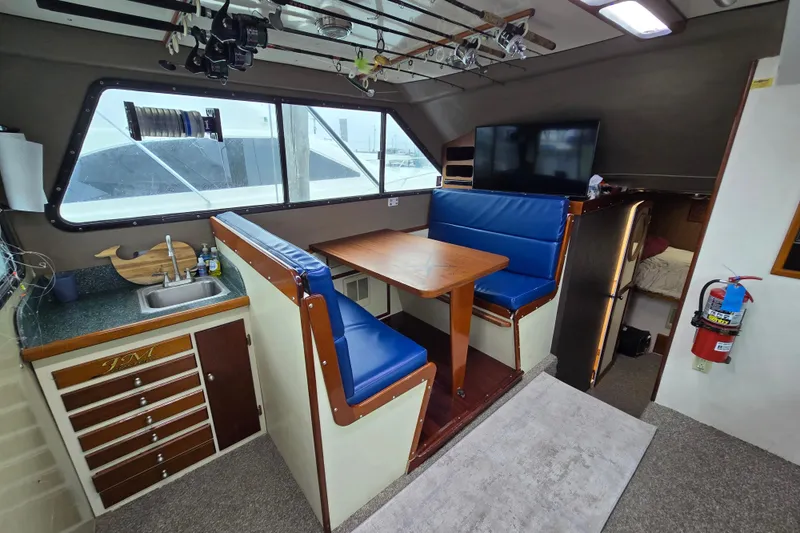 Slide: The Image of Interior of 2000 Custom 42 JM Sportfish boat with dining area and kitchenette. - 30