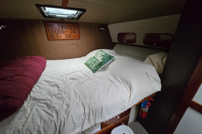 Slide: The Image of Cozy cabin interior of 2000 Custom 42 JM Sportfish boat with bed and storage. - 35