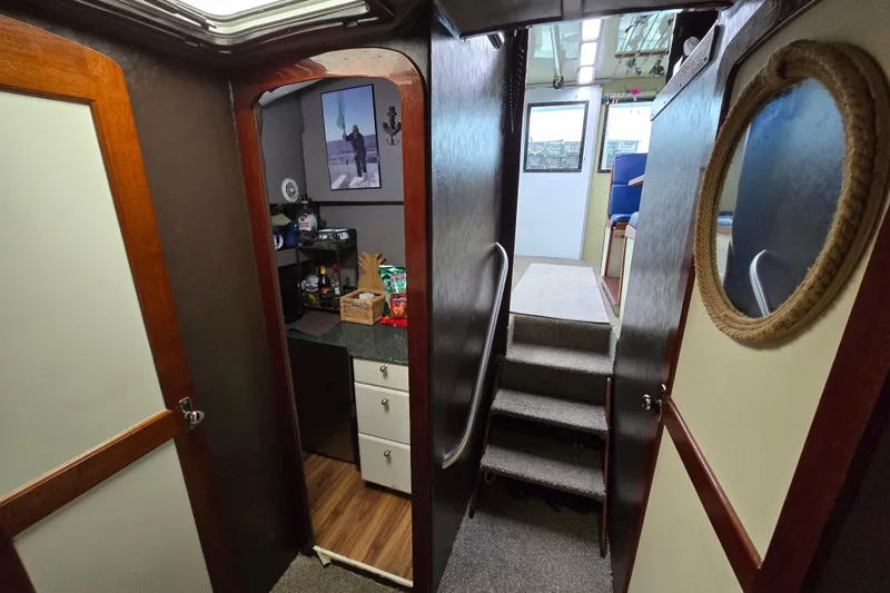 Slide: The Image of Interior of 2000 Custom 42 JM Sportfish boat with stairs and kitchenette area. - 37