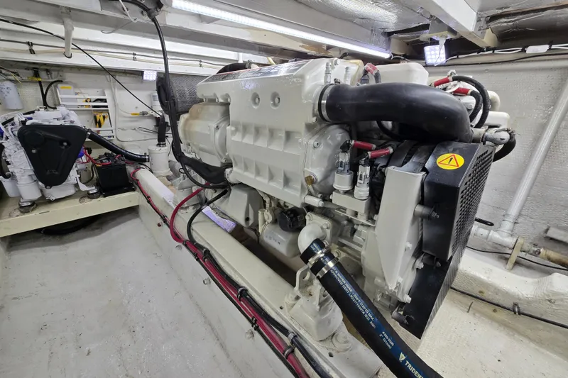 Slide: The Image of Engine room of a 2000 Custom 42 JM Sportfish boat, showcasing detailed machinery. - 39
