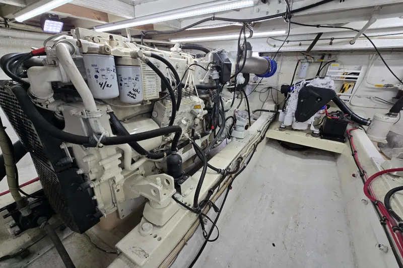 Slide: The Image of Engine room of 2000 Custom 42 JM Sportfish boat, showcasing detailed machinery and components. - 40