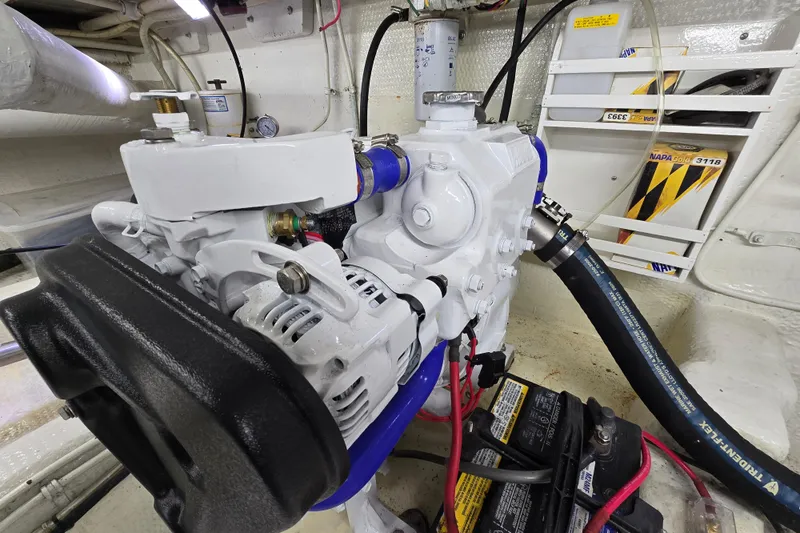 Slide: The Image of Engine room of 2000 Custom 42 JM Sportfish, featuring mechanical components and battery setup. - 41