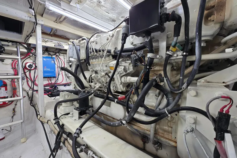 Slide: The Image of Engine room of 2000 Custom 42 JM Sportfish boat with visible wiring and components. - 43