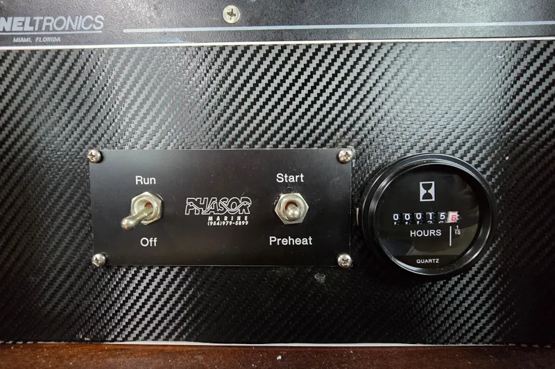 Slide: The Image of Control panel of a 2000 Custom 42 JM Sportfish boat with hour meter and switches. - 45