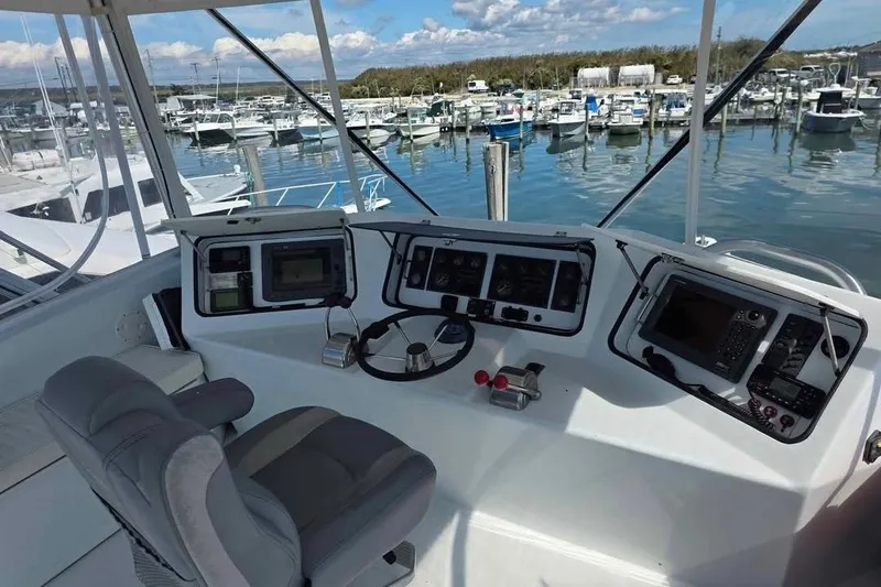 Slide: The Image of Cockpit of 2000 JM Custom 42 boat with navigation equipment and marina view. - 6