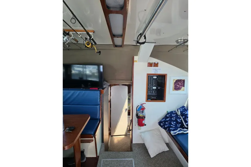 Slide: The Image of Interior of 2000 JM Custom 42 boat with seating, TV, and safety equipment. - 7