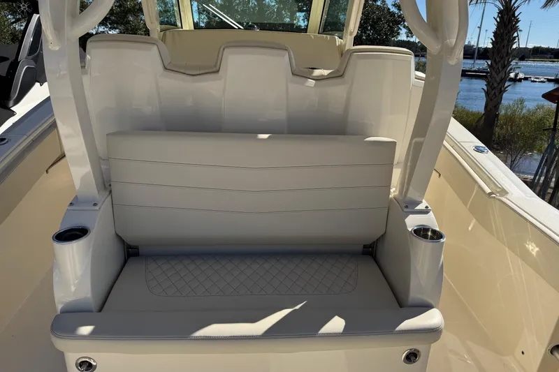 Slide: The Image of 2025 Scout 357 LXF boat seating area with cup holders, featuring luxurious white upholstery. - 13