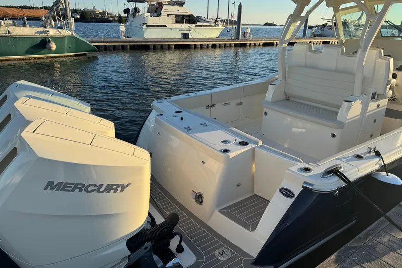 Slide: The Image of 2025 Scout 357 LXF boat with Mercury engines docked at marina. - 15