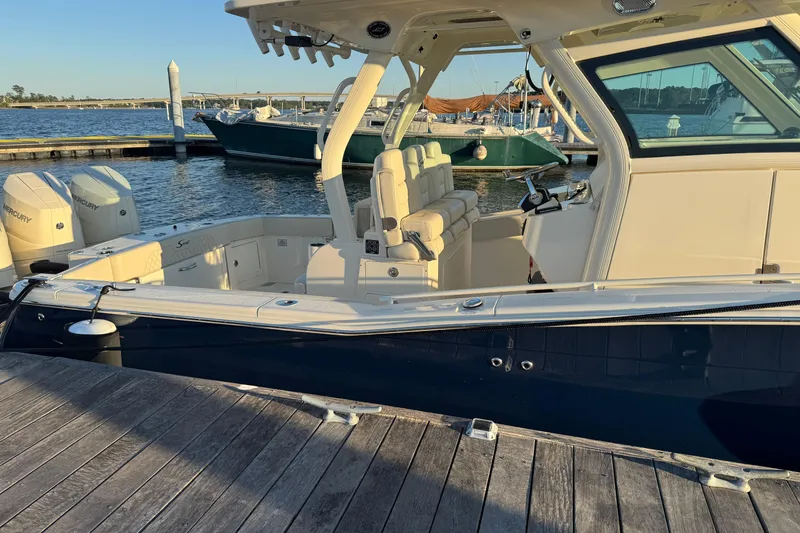 Slide: The Image of 2025 Scout 357 LXF boat docked with Mercury engines. - 4