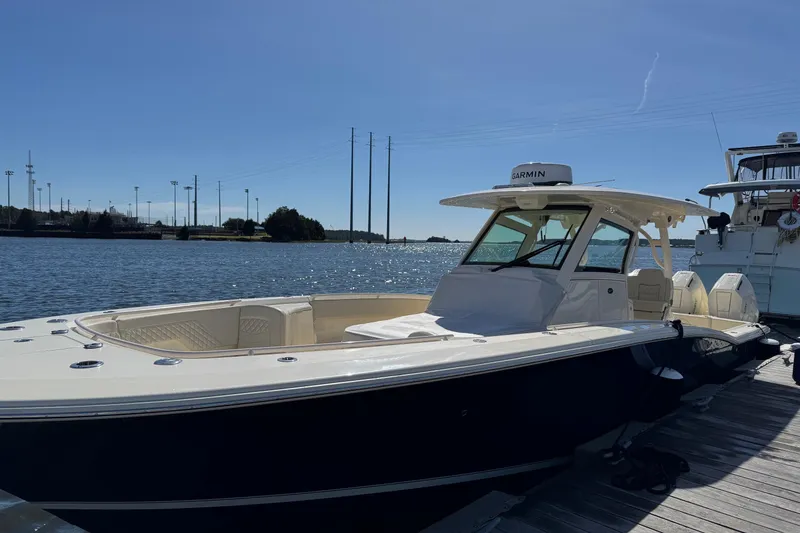 Slide: The Image of Scout 357 LXF 2025 boat docked on a sunny day. - 5