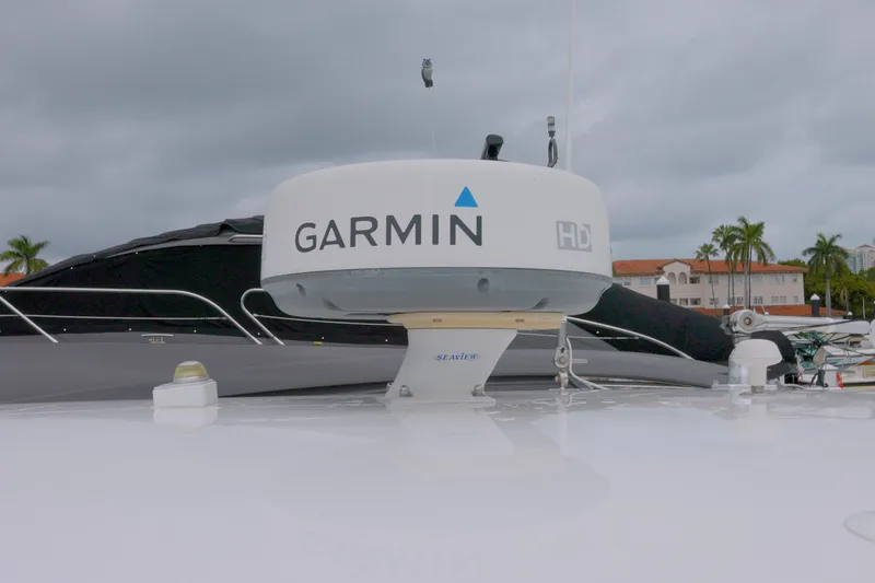Slide: The Image of Garmin radar on 2014 Intrepid 327 Cuddy boat, docked with palm trees in background. - 18