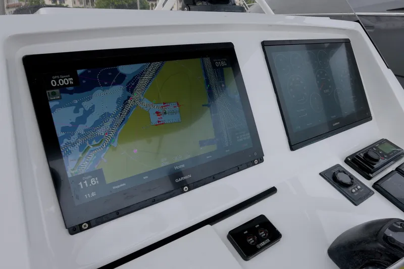 Slide: The Image of 2014 Intrepid 327 Cuddy boat dashboard with Garmin navigation screens. - 7