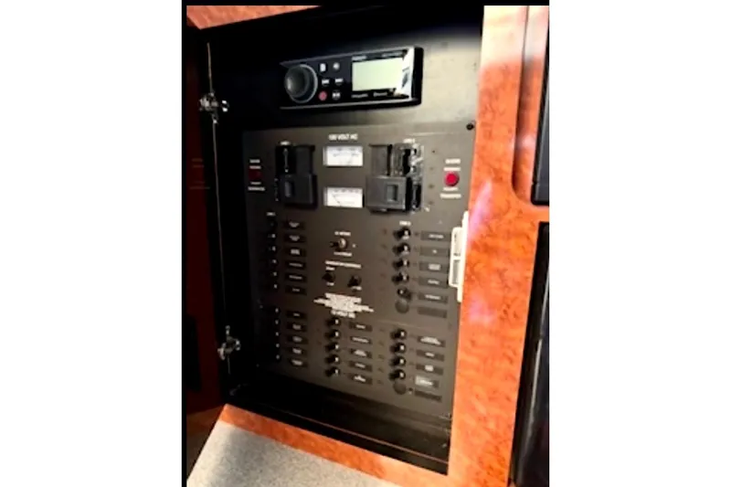 Slide: The Image of Electrical control panel on 2002 Wellcraft 3300 Martinique boat, featuring switches and meters. - 10