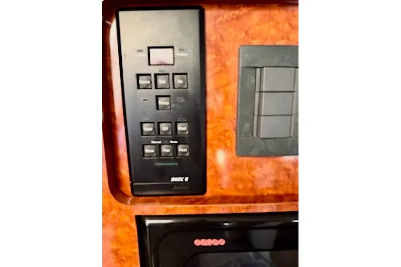 Slide: The Image of Control panel on 2002 Wellcraft 3300 Martinique boat, featuring various switches and buttons. - 15