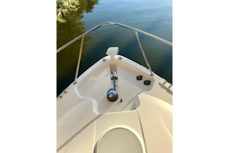 Slide: The Image of Bow view of 2002 Wellcraft 3300 Martinique boat on calm water. - 2