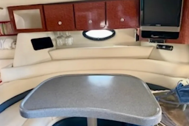 Slide: The Image of Interior of 2002 Wellcraft 3300 Martinique boat with table, seating, and cabinets. - 5