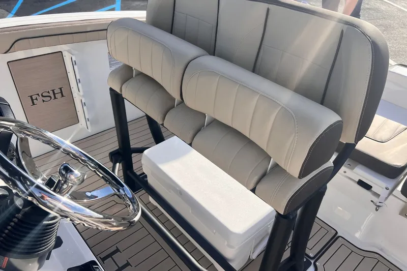Slide: The Image of Interior of 2026 Yamaha 255 FSH Sport E with steering wheel and seats. - 10
