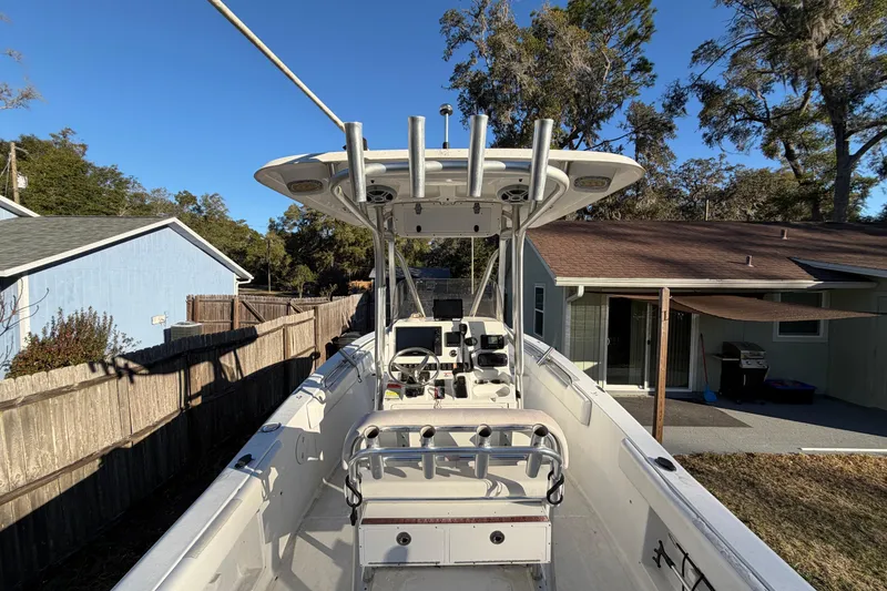 Slide: The Image of 2015 Sea Hunt Ultra 225 boat parked in a residential backyard. - 17