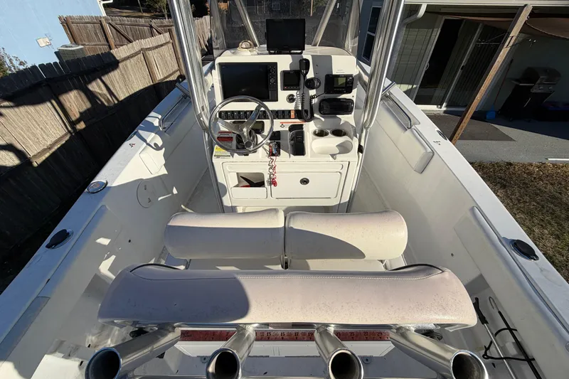 Slide: The Image of 2015 Sea Hunt Ultra 225 boat interior with steering console and seating. - 22