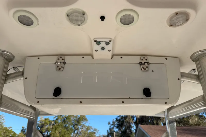 Slide: The Image of 2015 Sea Hunt Ultra 225 boat console with storage compartment and mounted lights. - 24