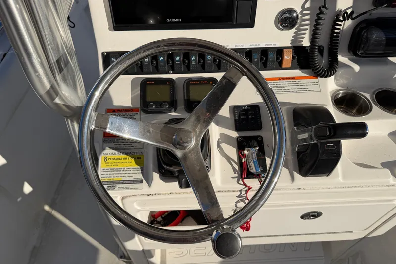 Slide: The Image of Steering console of a 2015 Sea Hunt Ultra 225 boat with controls and gauges. - 28