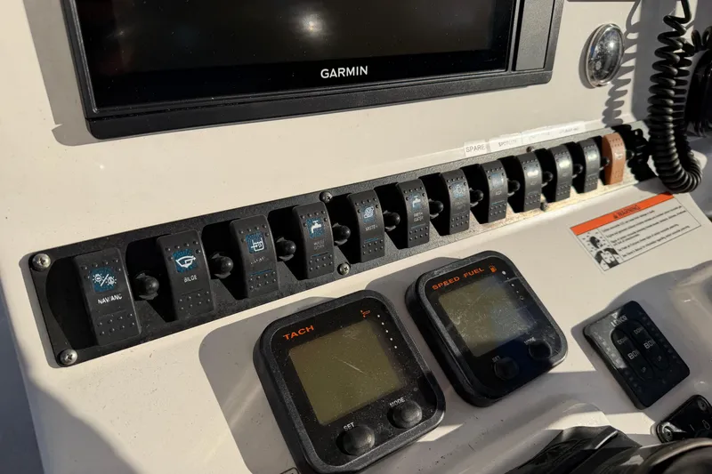 Slide: The Image of Control panel of a 2015 Sea Hunt Ultra 225 boat with Garmin display and switches. - 29