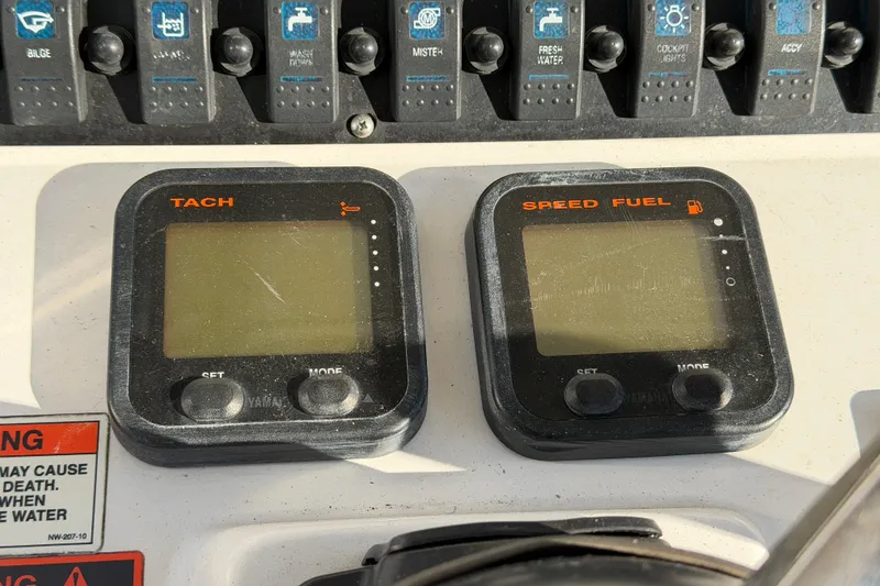 Slide: The Image of Dashboard of a 2015 Sea Hunt Ultra 225 boat with tachometer and speed fuel gauges. - 30