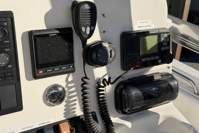 Slide: The Image of Control panel of a 2015 Sea Hunt Ultra 225 boat with Garmin and Icom devices. - 31