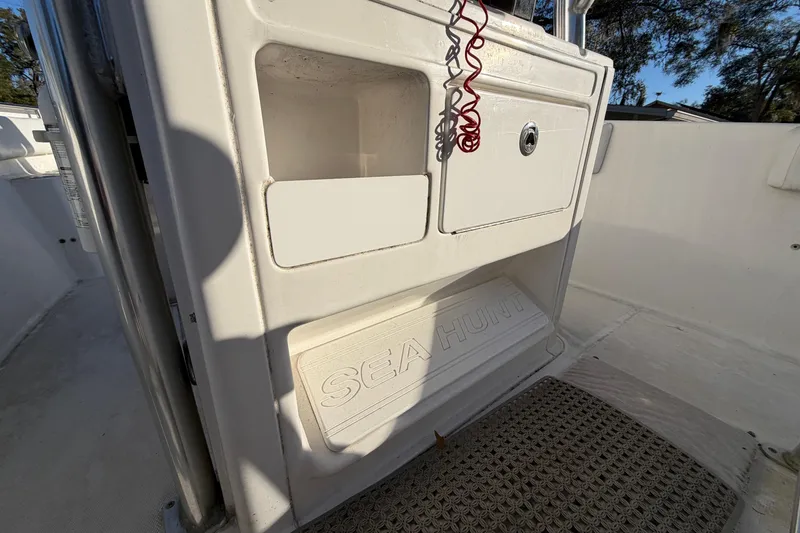 Slide: The Image of 2015 Sea Hunt Ultra 225 boat interior with storage compartments and Sea Hunt branding. - 36