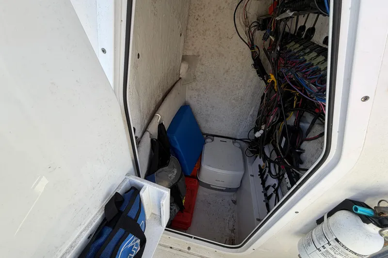 Slide: The Image of Interior of a 2015 Sea Hunt Ultra 225 boat showing wiring and storage compartments. - 39