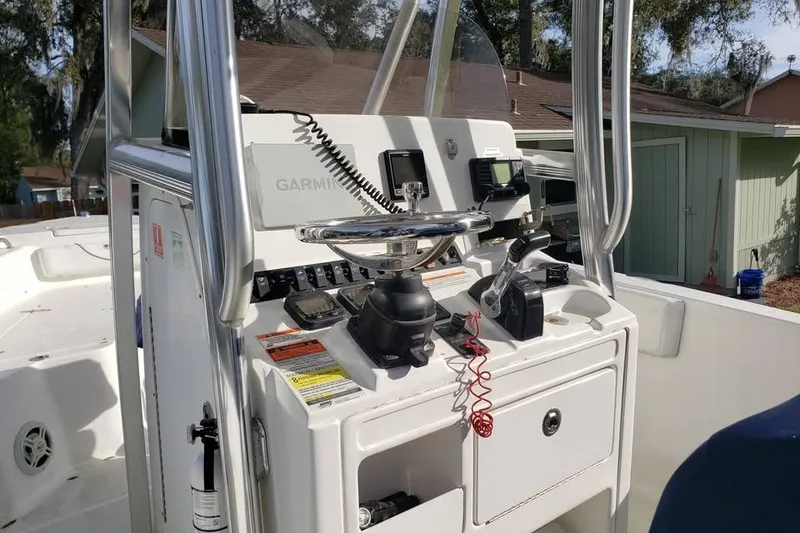 Slide: The Image of 2015 Sea Hunt Ultra 225 boat with Yamaha 250 outboard motor in backyard setting. - 4
