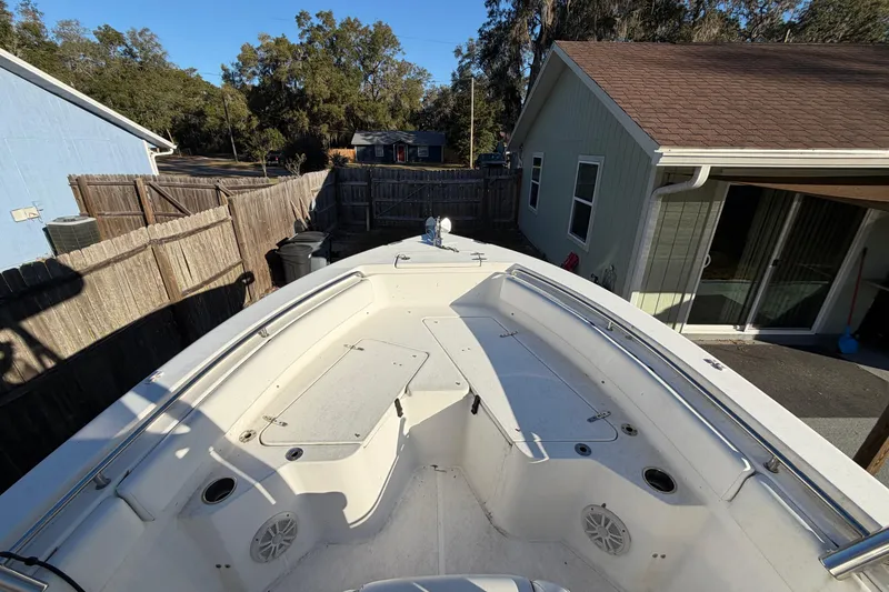 Slide: The Image of 2015 Sea Hunt Ultra 225 boat parked in a residential driveway. - 41