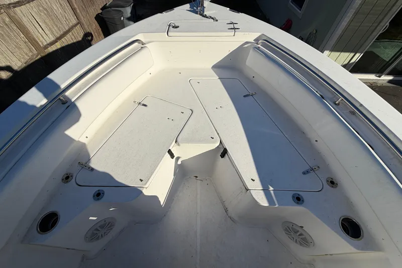 Slide: The Image of 2015 Sea Hunt Ultra 225 boat interior with storage compartments and seating area. - 44