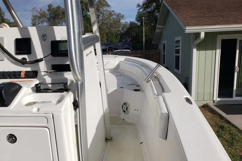 Slide: The Image of 2015 Sea Hunt Ultra 225 with Yamaha 250 outboard engine, parked outdoors. - 5